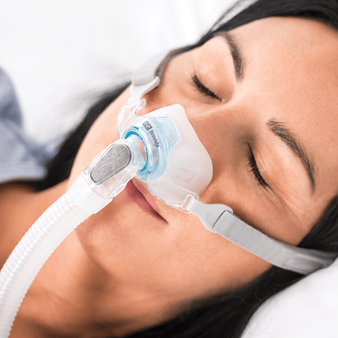 woman sleeping wearing brevida nasal pillows mask