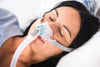 Woman in bed wear brevida nasal pillow mask