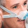 man wearing brevida nasal pillows mask