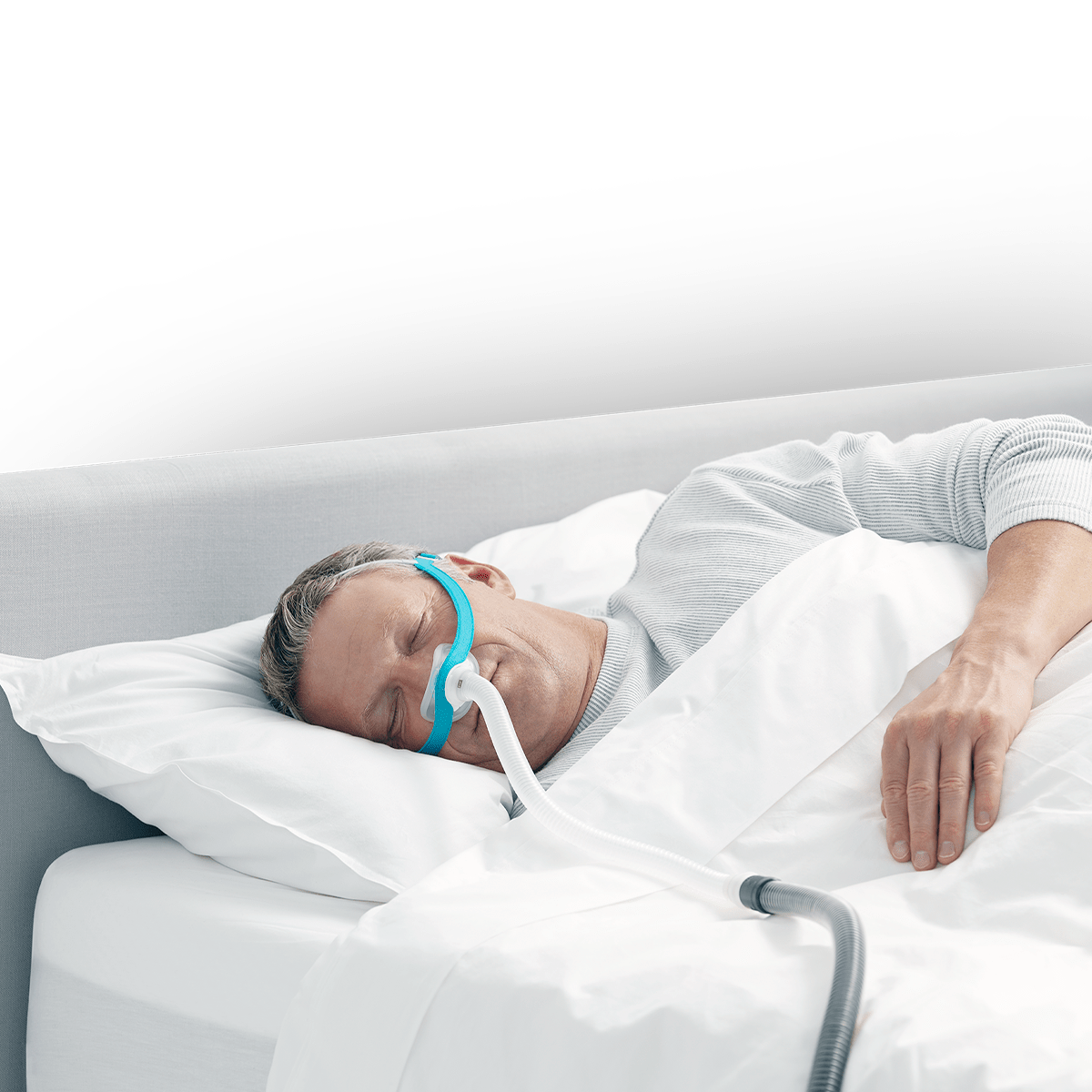 man sleeping on side wearing evora nasal mask