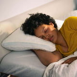 woman sleeping on her side on the Adjustable Shredded Memory Foam Pillow