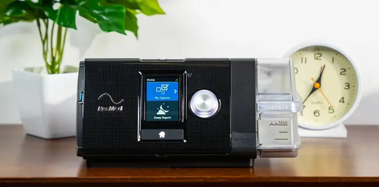 ResMed AirSense 10 CPAP machine on a night stand.